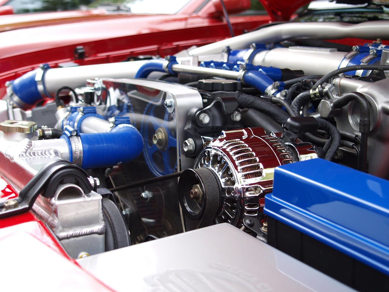 about-us Detailed view of a clean modern car engine with vibrant colored components and sleek design.